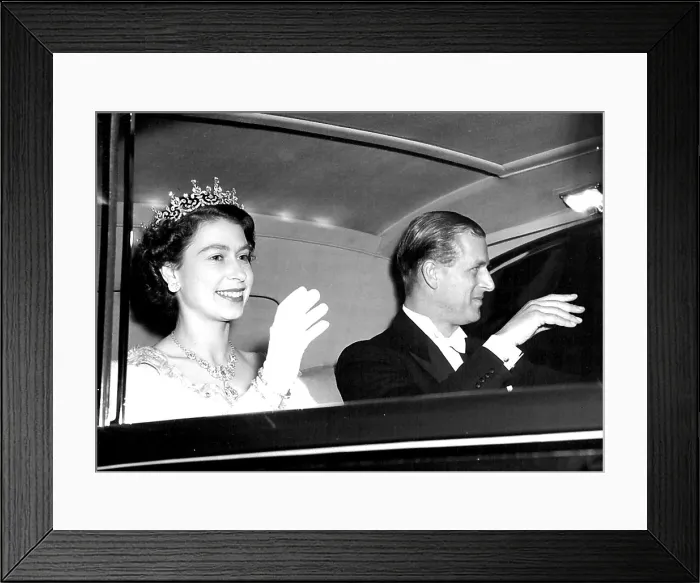 Framed Print : The Queen and the Duke of Edinburgh acknowledge the cheers of the crowds as they drives away from the Odeon Leicester
