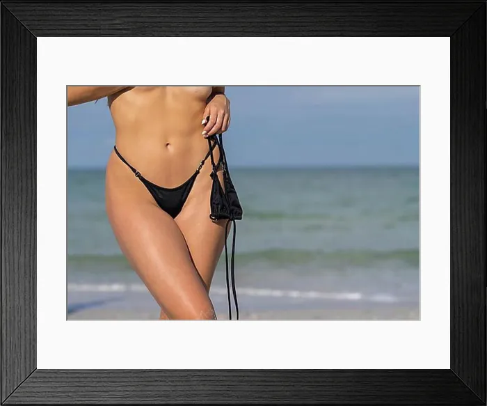 Framed Print : A beautiful Mixed-race bikini model enjoys the weather outdoors on the beach