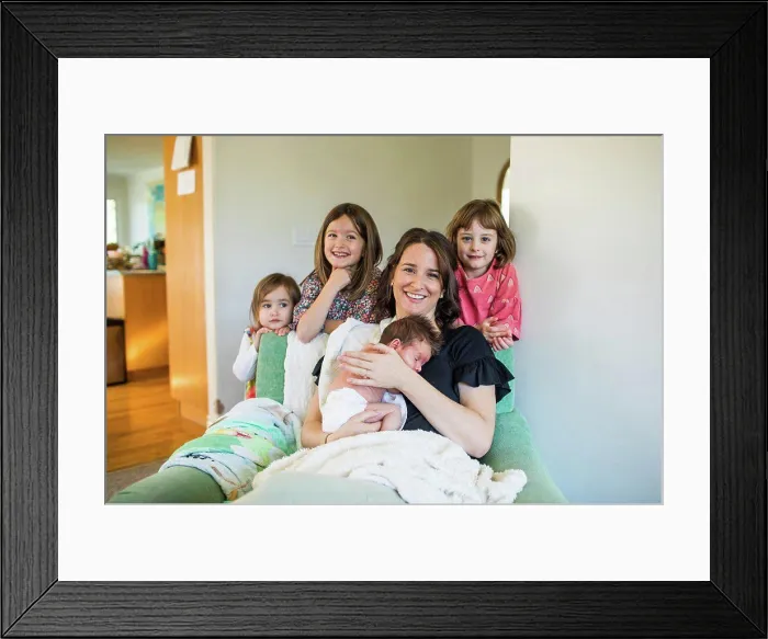 Framed Print : Mother of four holding her newborn baby Framed Print : Mother of four holding her newborn baby
