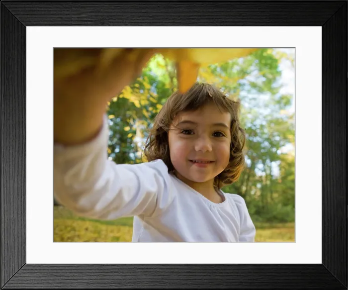 Framed Print : Four year old girl looking at camera. with Leaves in her hand, Seattle, Washington (MR) Framed Print : Four year old girl looking at camera. with Leaves in her hand, Seattle, Washington (MR)
