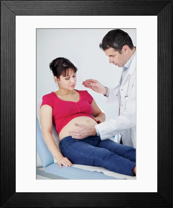 Framed Print : Pregnant woman in consultation