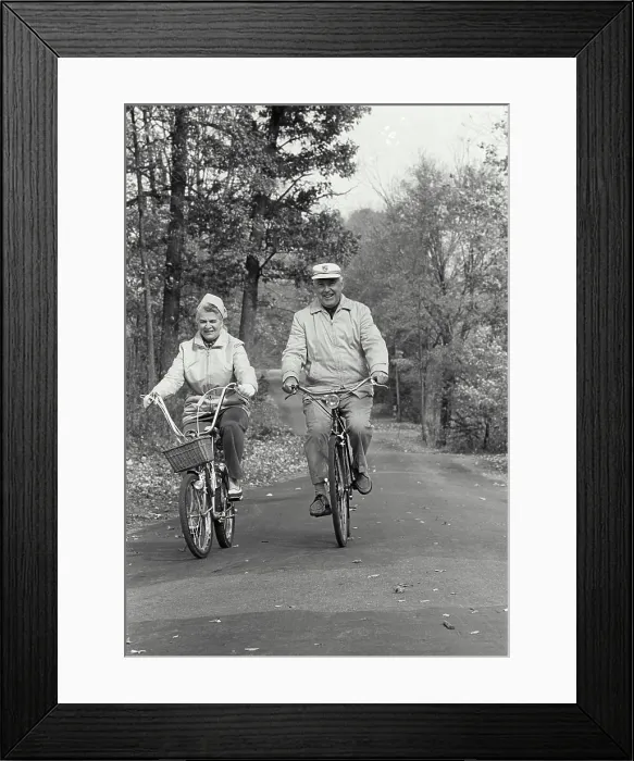 Framed Print : Vintage Photograph. Elderly couple riding bicycles down autumn road Framed Print : Vintage Photograph. Elderly couple riding bicycles down autumn road