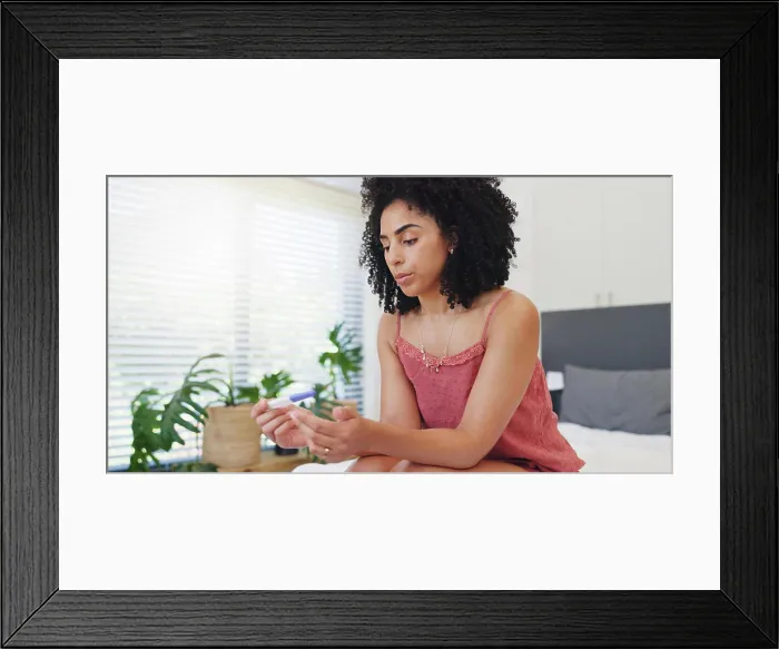 Framed Print : Anxiety, woman and stress with pregnancy test on bed for fertility Framed Print : Anxiety, woman and stress with pregnancy test on bed for fertility