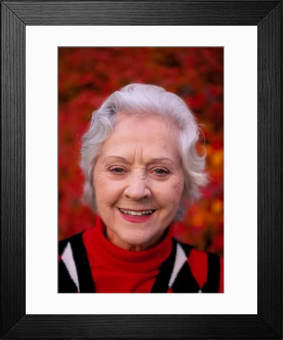 Framed Print : Portrait of a smiling silver-haired senior woman wearing a red white and blue sweater Framed Print : Portrait of a smiling silver-haired senior woman wearing a red white and blue sweater