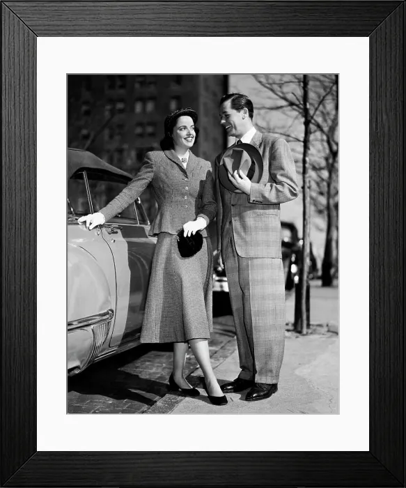 Framed Print : Young couple standing near a car Framed Print : Young couple standing near a car