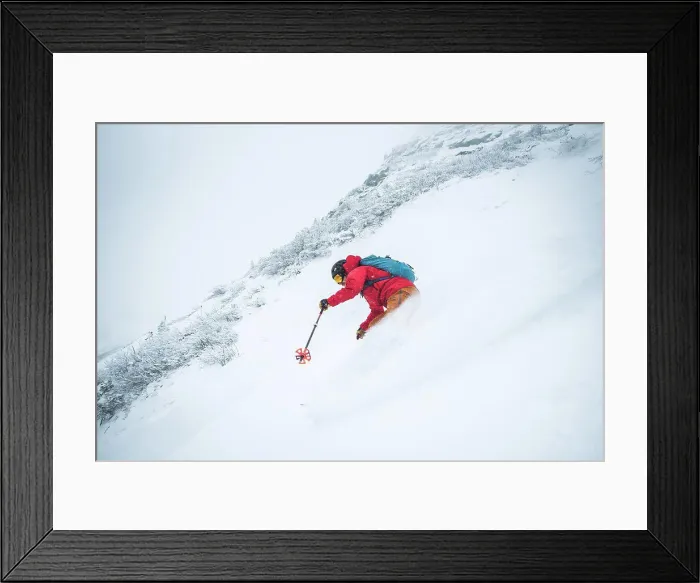 Framed Print : Man skiing in deep snow in the alpine during a snowstorm in Maine Framed Print : Man skiing in deep snow in the alpine during a snowstorm in Maine