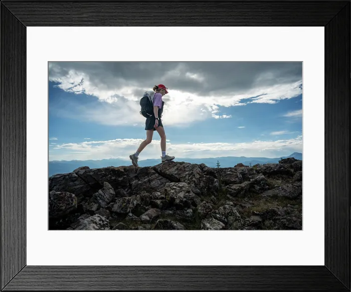 Framed Print : Adventurous Solo Hiker Exploring Rocky Mountain Trail Under a Majestic Sky