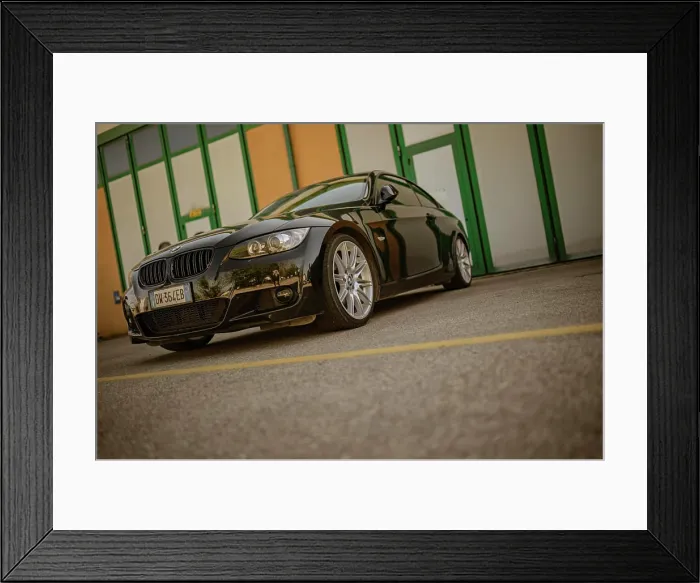 Framed Print : Rome, Italy 18 April 2024: A black car is parked in front of a building on a city street Framed Print : Rome, Italy 18 April 2024: A black car is parked in front of a building on a city street