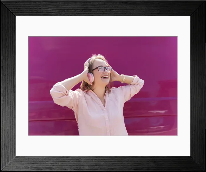 Framed Print : woman listens music in headphones and laughs on pink background Framed Print : woman listens music in headphones and laughs on pink background