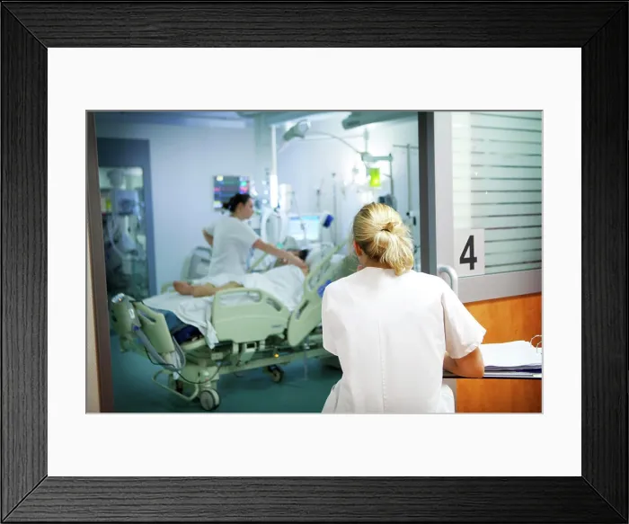 Framed Print : Reportage in Robert Ballanger hospital's Intensive Care Unit in France. A nurse notes down a patient's vital parameters Framed Print : Reportage in Robert Ballanger hospital's Intensive Care Unit in France. A nurse notes down a patient's vital parameters
