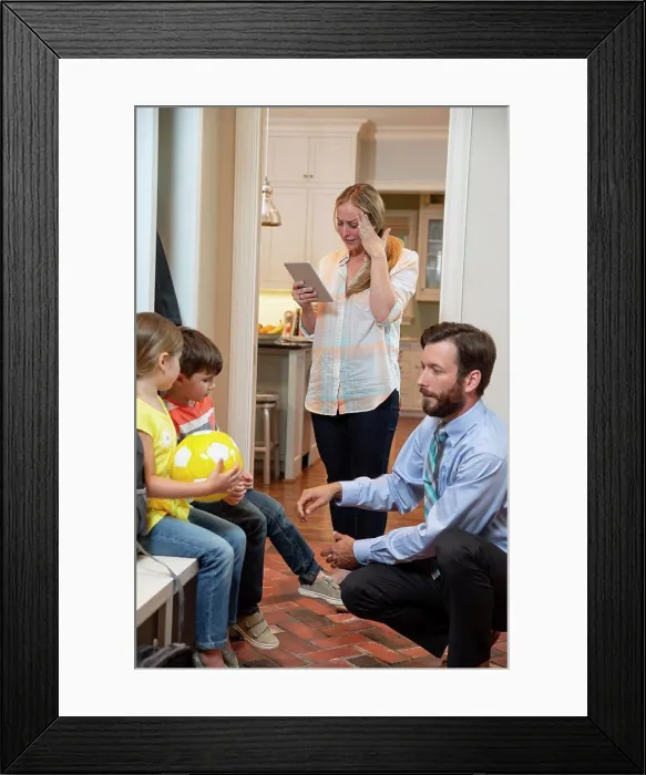 Framed Print : Family in the morning getting, dad getting kids shoes on in mudroom before taking off for school Framed Print : Family in the morning getting, dad getting kids shoes on in mudroom before taking off for school