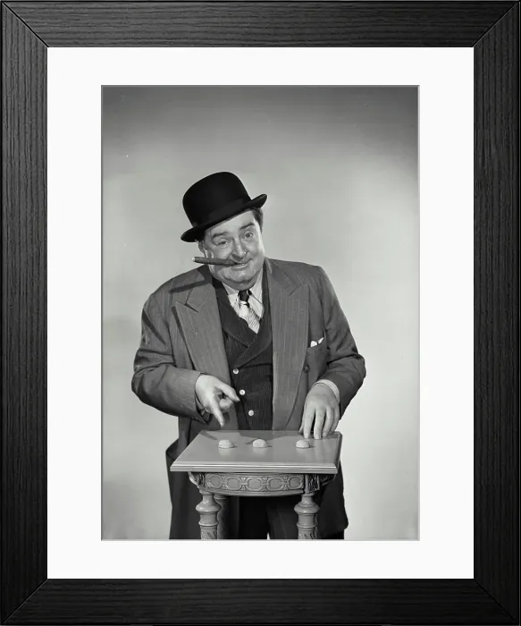 Framed Print : Vintage Photograph. Street gambler with cigar in mouth pointing at shells of nuts for game Framed Print : Vintage Photograph. Street gambler with cigar in mouth pointing at shells of nuts for game