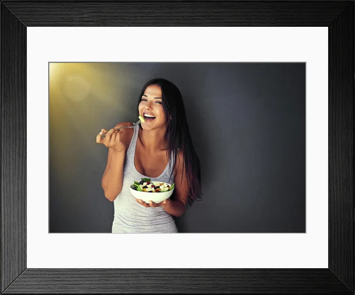 Framed Print : Happy woman is eating a salad, healthy food and nutrition