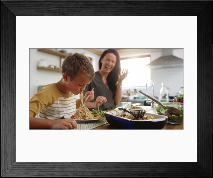 Framed Print : Laugh, food and pasta with family at kitchen table for nutrition