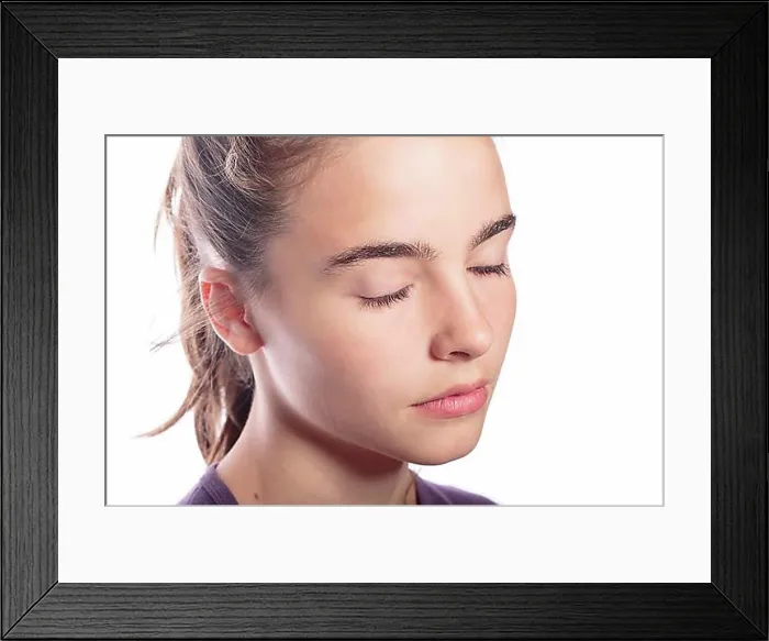 Framed Print : Portrait of a teenage girl with closed eyes, isolated on white Framed Print : Portrait of a teenage girl with closed eyes, isolated on white