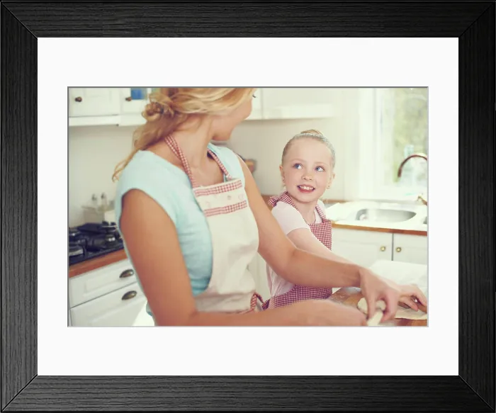 Framed Print : Mother, girl and dough for cake in kitchen