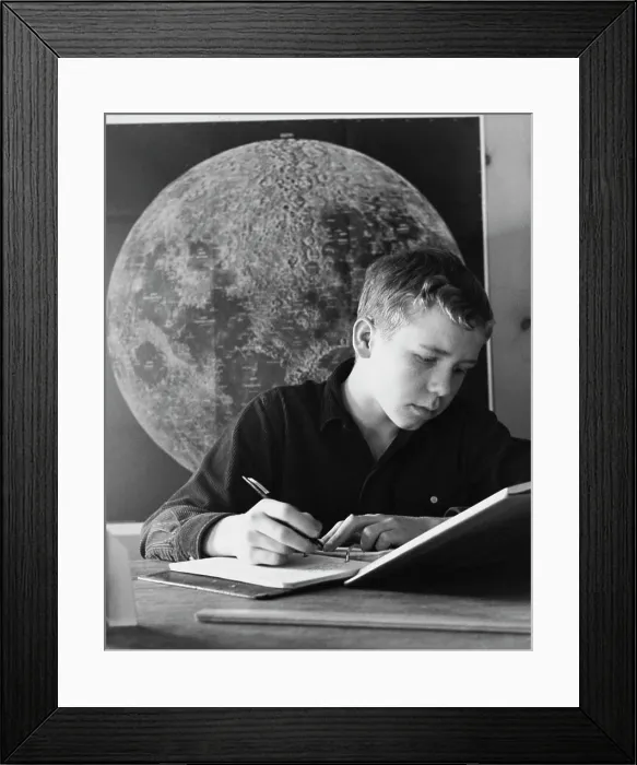 Framed Print : Teenage boy writing in a spiral notebook Framed Print : Teenage boy writing in a spiral notebook