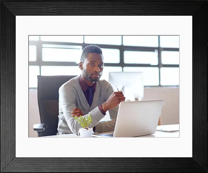 Framed Print : Portrait, black man and technology on desk in office for creative job as web developer or graphic designer for company Framed Print : Portrait, black man and technology on desk in office for creative job as web developer or graphic designer for company
