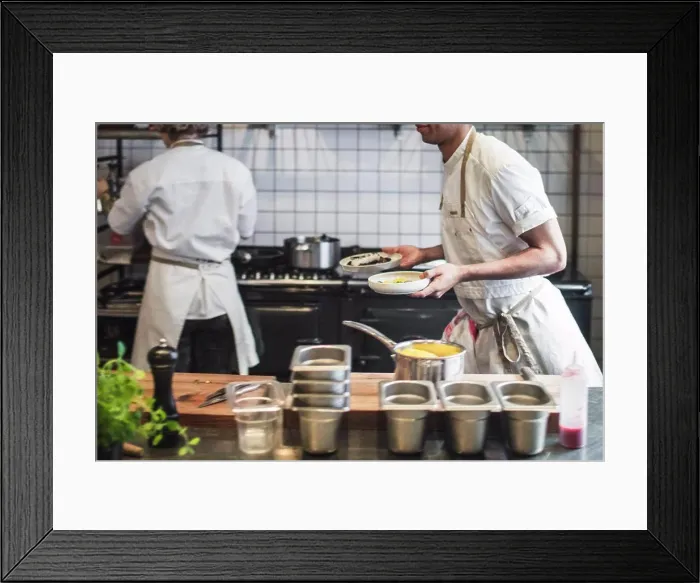 Framed Print : Midsection of waiter carrying food plates in kitchen at restaurant Framed Print : Midsection of waiter carrying food plates in kitchen at restaurant