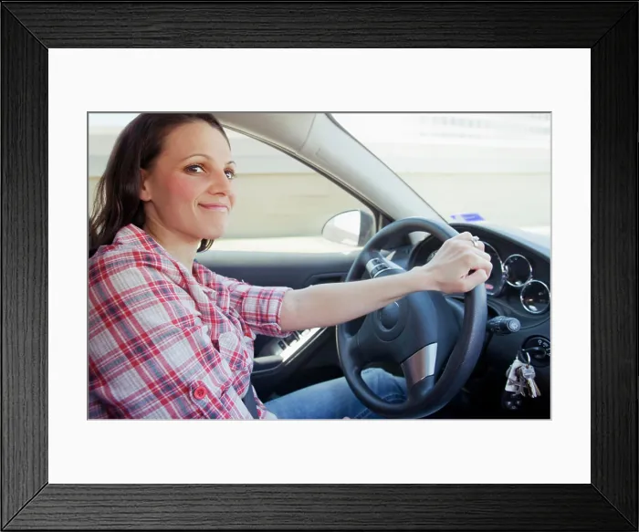 Framed Print : Smiling woman driving car Framed Print : Smiling woman driving car