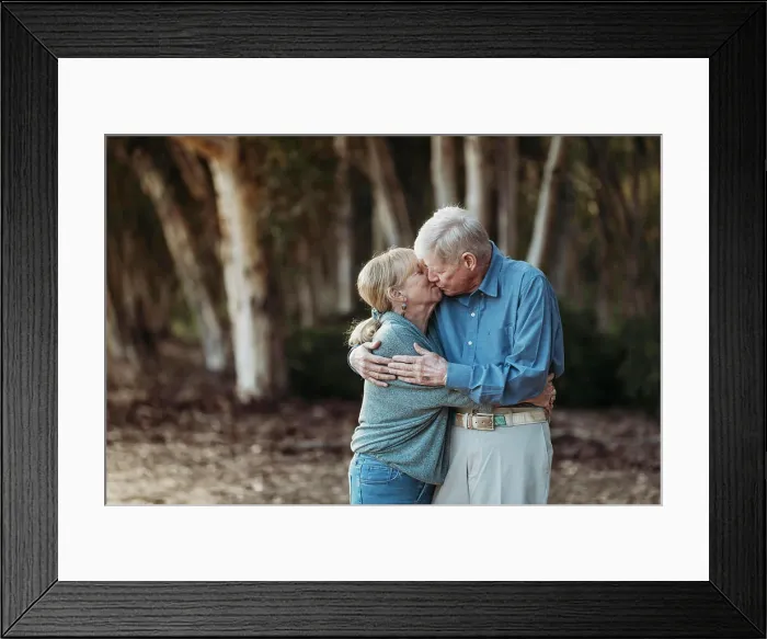 Framed Print : Portrait of senior adult retired couple kissing in forest Framed Print : Portrait of senior adult retired couple kissing in forest