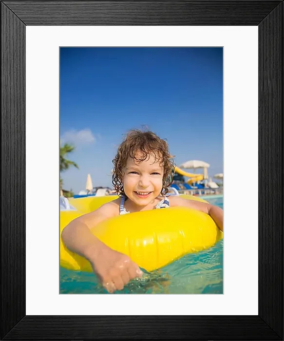 Framed Print : Happy child playing in swimming pool. Summer vacations concept