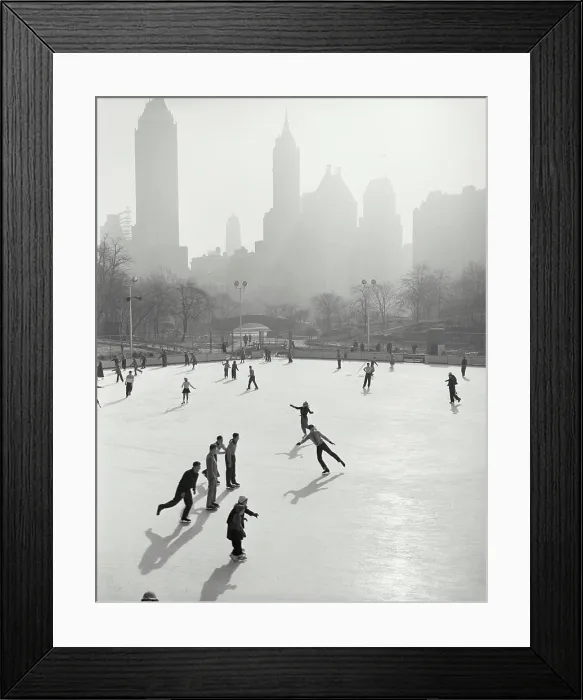 Framed Print : Vintage photograph. People skating at Wollman Memorial Ice Rink in Central Park with hazy buildings in background