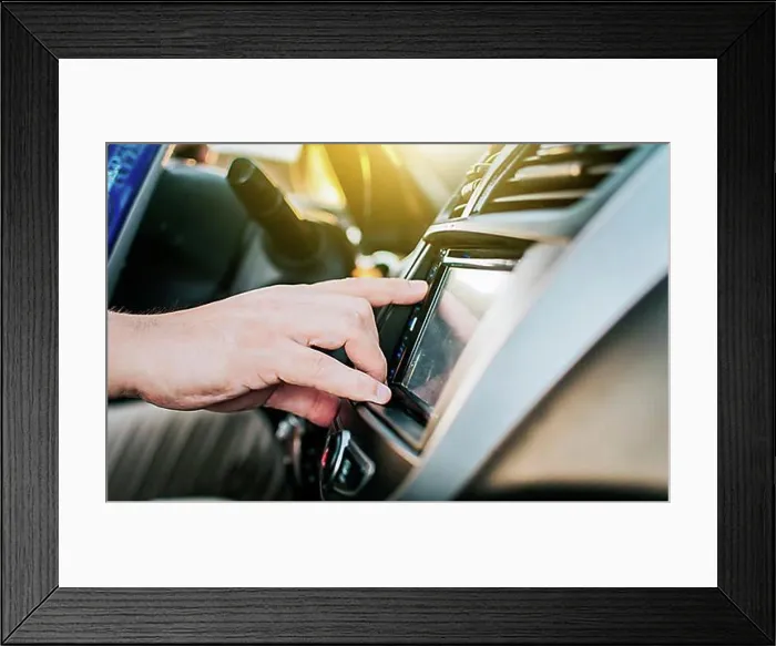 Framed Print : Close up of hands changing the car radio station