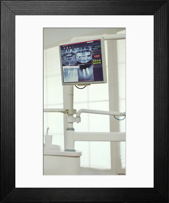 Framed Print : Pediatric dentist showing on monitor teeth x-ray Framed Print : Pediatric dentist showing on monitor teeth x-ray
