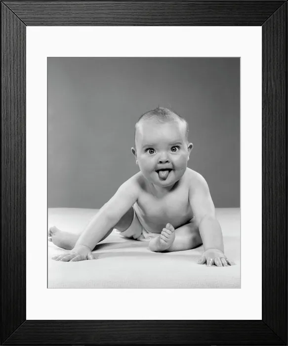 Framed Print : 1950S Portrait Of Baby Sitting And Sticking Tongue Out Indoor Framed Print : 1950S Portrait Of Baby Sitting And Sticking Tongue Out Indoor