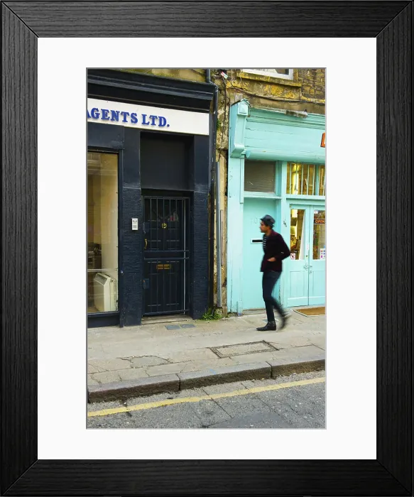 Framed Print : Pedestrian Walking Along Street Beside Retail Buildings, Brick Lane; London, England Framed Print : Pedestrian Walking Along Street Beside Retail Buildings, Brick Lane; London, England