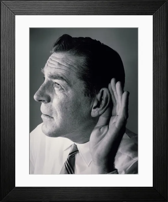 Framed Print : Close-up of a mature man with a cupped hand to his ear Framed Print : Close-up of a mature man with a cupped hand to his ear
