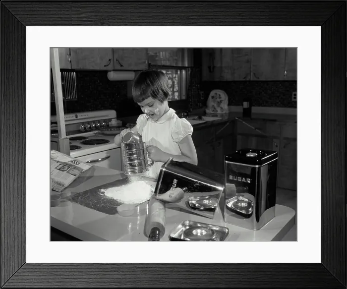 Framed Print : Girl working in a kitchen
