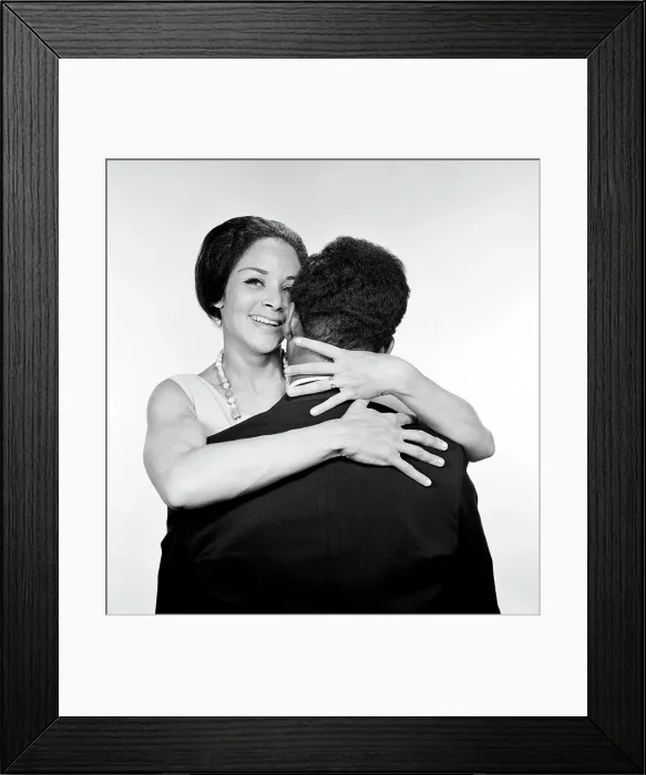 Framed Print : Embracing African-american married couple, studio shot