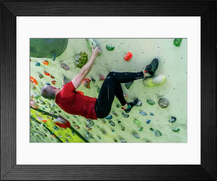 Framed Print : young man climbing on the climbing wall Framed Print : young man climbing on the climbing wall