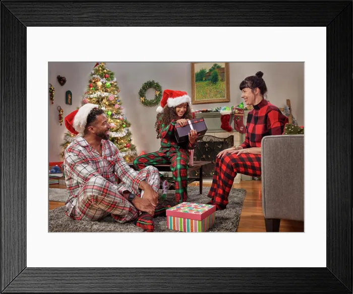 Framed Print : Young family and their daughter opening gifts and celebrating Christmas while in their Pajamas Framed Print : Young family and their daughter opening gifts and celebrating Christmas while in their Pajamas