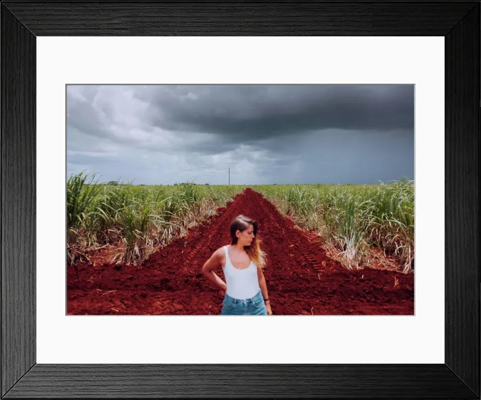 Framed Print : Female traveler in casual wear standing on crossroad with brown soil among green tropical plants under grey cloudy Framed Print : Female traveler in casual wear standing on crossroad with brown soil among green tropical plants under grey cloudy