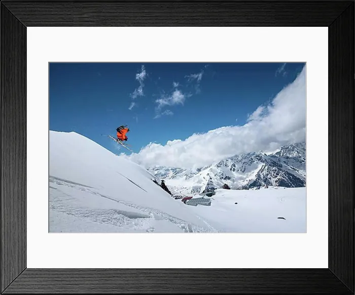 Framed Print : Athlete skier freestyle jumping in orange ski suit in snowy mountains on a sunny day Framed Print : Athlete skier freestyle jumping in orange ski suit in snowy mountains on a sunny day