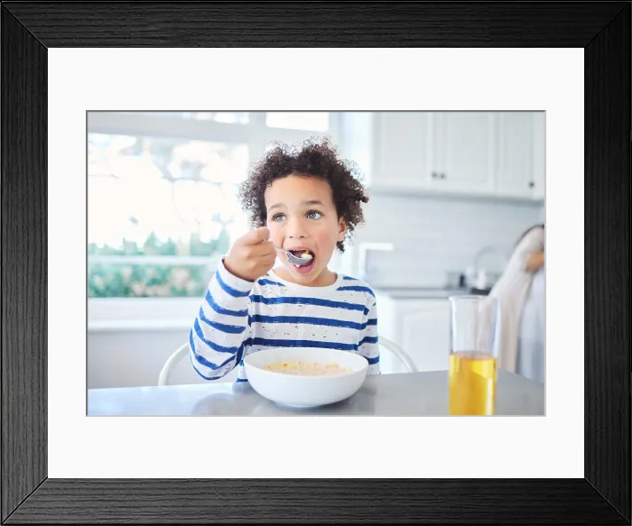 Framed Print : Boy, child and breakfast cereal in home Framed Print : Boy, child and breakfast cereal in home