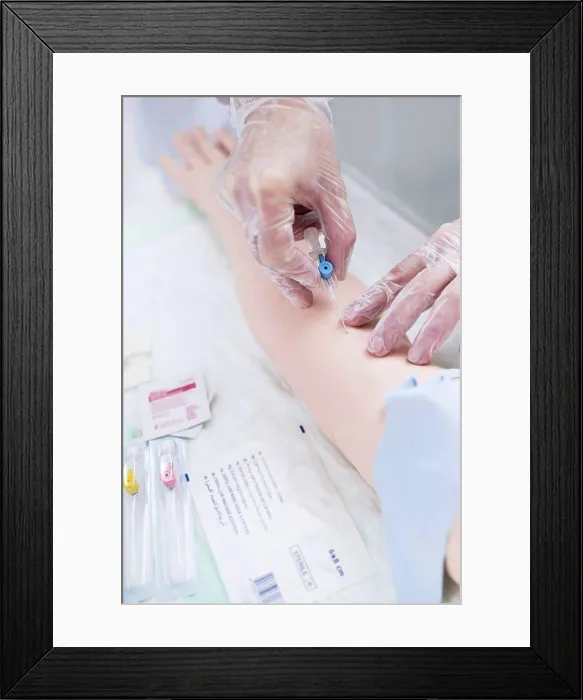 Framed Print : Doctor practising inserting an IV line Framed Print : Doctor practising inserting an IV line