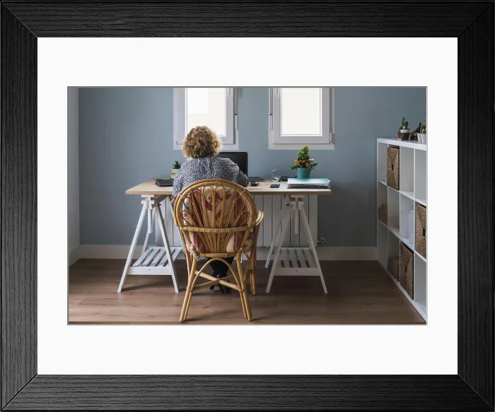 Framed Print : Back view of adult woman in casual clothes working on laptop in earphones at room decorated with cactuses in ceramic Framed Print : Back view of adult woman in casual clothes working on laptop in earphones at room decorated with cactuses in ceramic