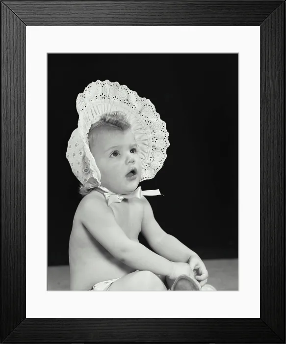 Framed Print : Close-up of a baby girl wearing a bonnet