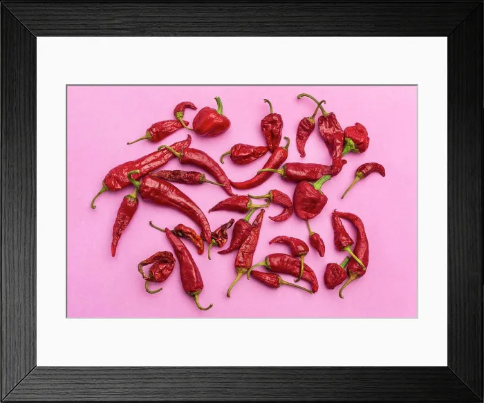 Framed Print : Red chili peppers on bright pink background Framed Print : Red chili peppers on bright pink background