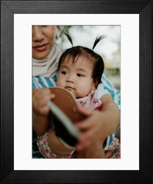 Framed Print : Mother holding baby girl in the park Framed Print : Mother holding baby girl in the park