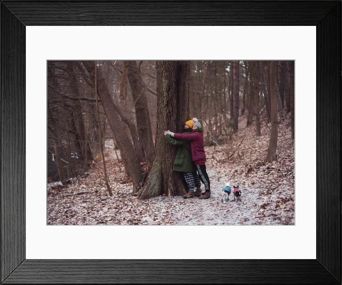 Framed Print : Lesbian couple hug a tree together with small dogs in winter germany Framed Print : Lesbian couple hug a tree together with small dogs in winter germany