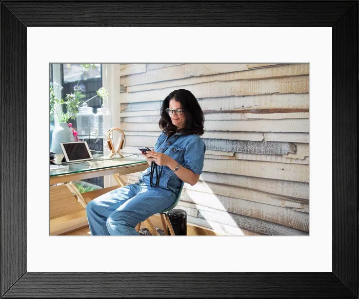 Framed Print : Smiling woman using smart phone in home office Framed Print : Smiling woman using smart phone in home office