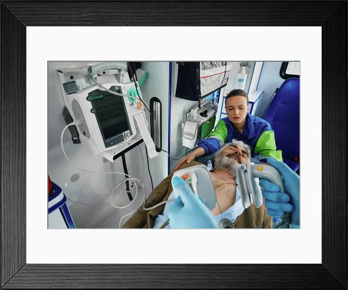 Framed Print : Paramedics treating patient in ambulance