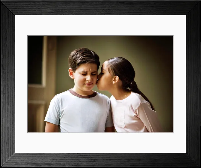 Framed Print : A small girl is kissing a small boy Framed Print : A small girl is kissing a small boy