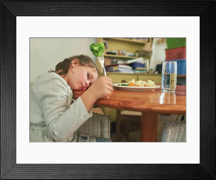 Framed Print : Angry, child and eating healthy food in home with vegetables