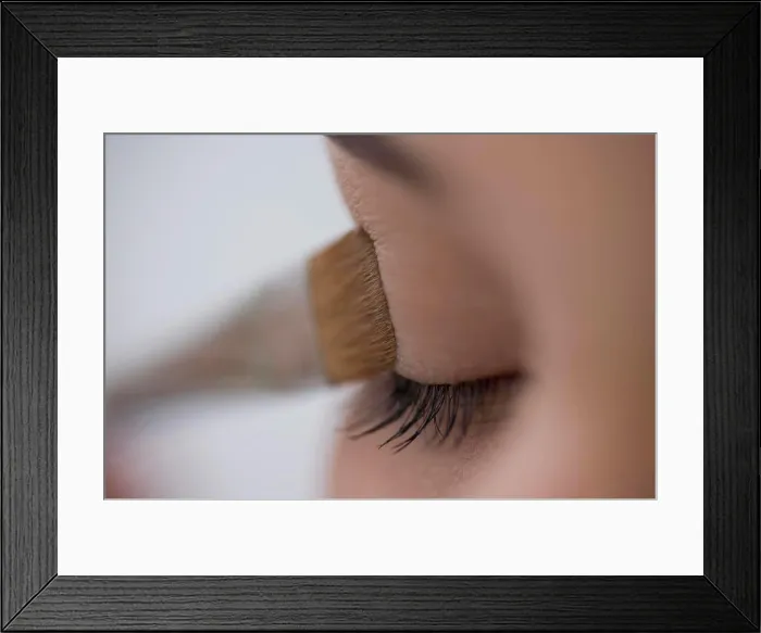 Framed Print : Close up of young woman eye with eyeshadow brush Framed Print : Close up of young woman eye with eyeshadow brush